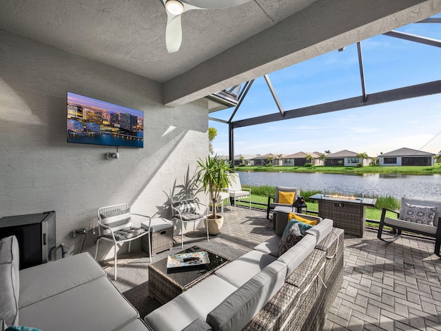 view of patio with a water view, glass enclosure, and an outdoor hangout area