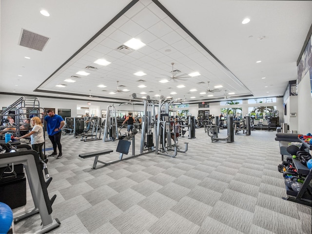 exercise room featuring ceiling fan and light colored carpet