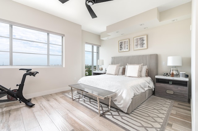 bedroom with ceiling fan and light hardwood / wood-style floors