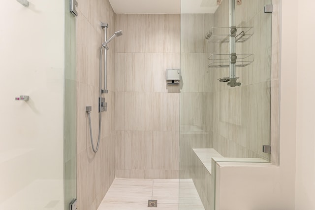 bathroom featuring a shower with shower door