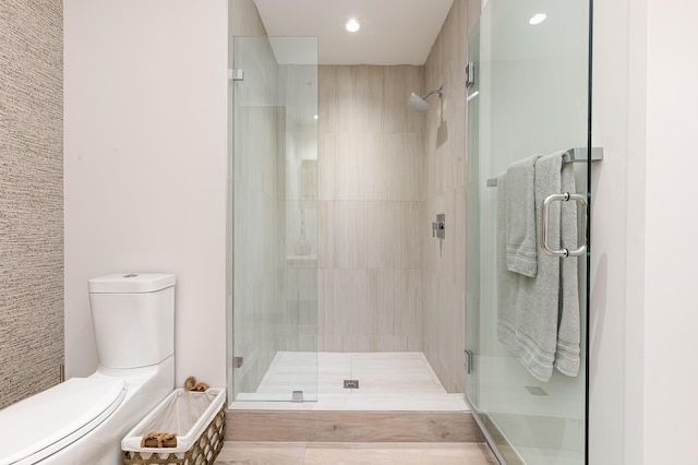 bathroom featuring tile patterned floors, walk in shower, and toilet