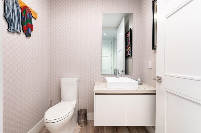 bathroom featuring vanity, hardwood / wood-style floors, and toilet