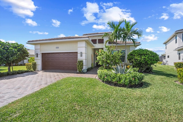 view of front of house featuring a front yard and a garage