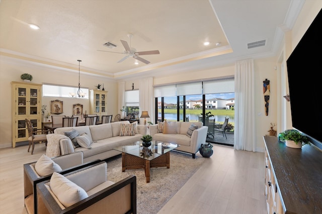 living room with crown molding, light wood-type flooring, and ceiling fan