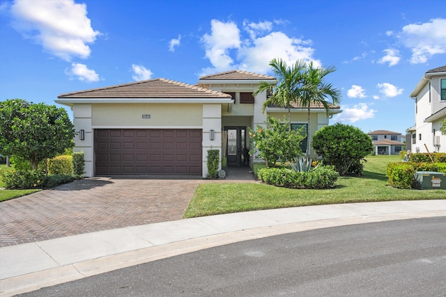 view of front of home featuring a front yard and a garage