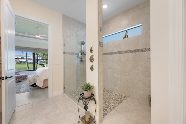 bathroom with a tile shower, ceiling fan, a wealth of natural light, and tile patterned flooring