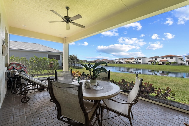 view of patio / terrace with a water view and ceiling fan