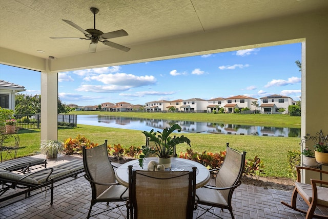 view of patio / terrace with a water view and ceiling fan