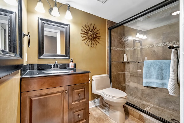 bathroom featuring tile patterned flooring, vanity, walk in shower, and toilet