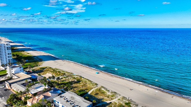 drone / aerial view featuring a water view and a view of the beach