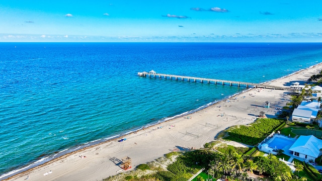 birds eye view of property with a beach view and a water view