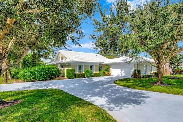 view of front facade with a front yard and a garage