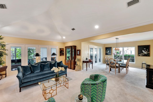 living room with a wealth of natural light, french doors, crown molding, and light colored carpet