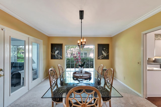 carpeted dining area featuring french doors, ornamental molding, and a chandelier