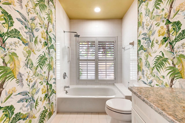 full bathroom featuring vanity, tiled shower / bath combo, toilet, and tile patterned flooring