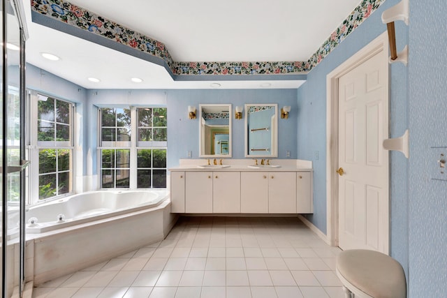 bathroom featuring vanity, a bath, and tile patterned flooring