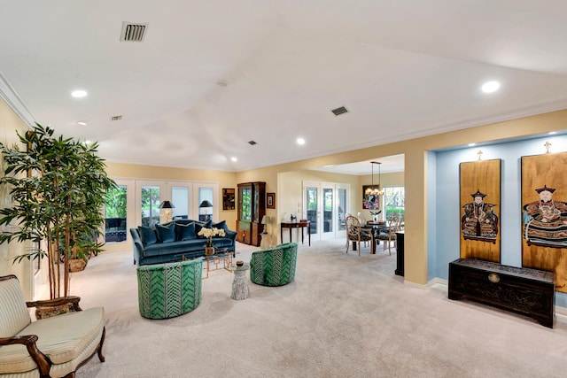 carpeted living room featuring a chandelier, crown molding, and french doors