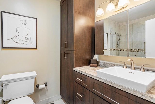 bathroom featuring tile patterned floors, vanity, toilet, and a shower with shower door