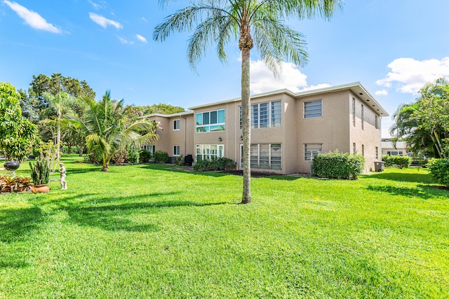 rear view of property with a lawn