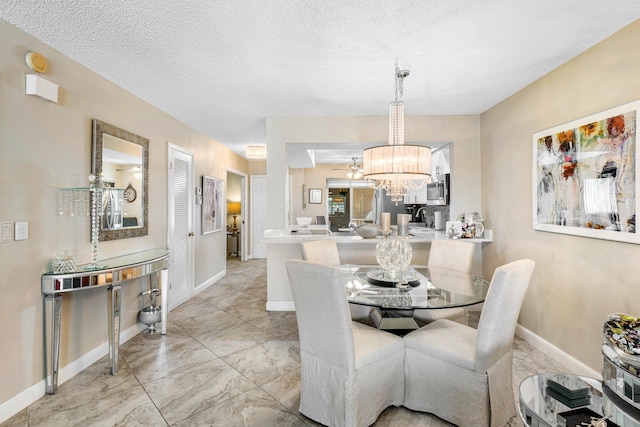 dining room featuring a textured ceiling, sink, and a chandelier