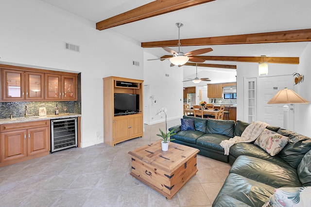 living room with beverage cooler, light tile patterned floors, visible vents, and wet bar