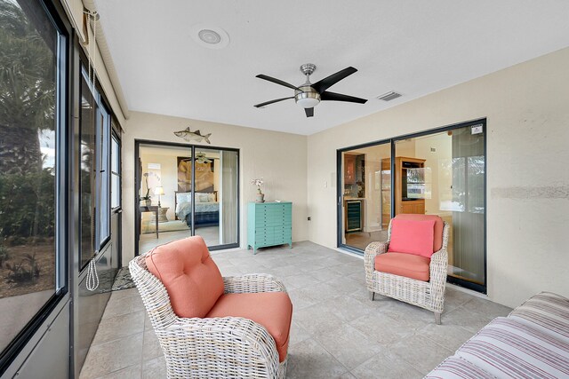 sunroom with ceiling fan and beverage cooler