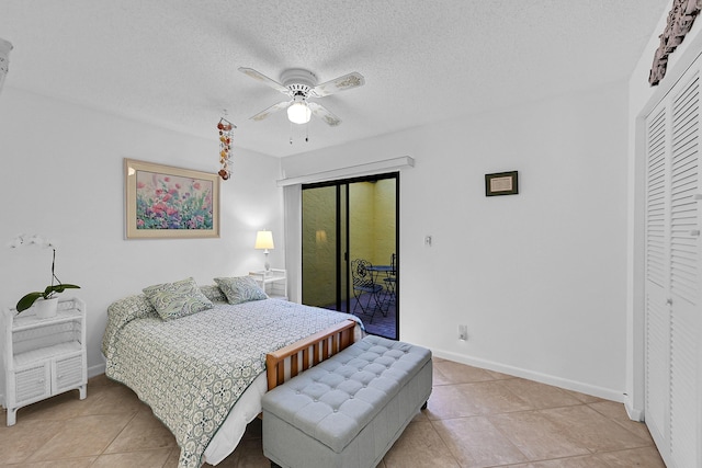 bedroom with a textured ceiling, light tile patterned floors, a ceiling fan, baseboards, and access to outside