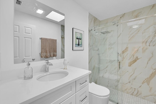 full bathroom featuring a skylight, visible vents, vanity, and a marble finish shower