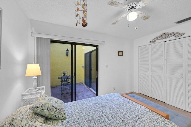 bedroom with a textured ceiling, ceiling fan, a closet, and access to outside