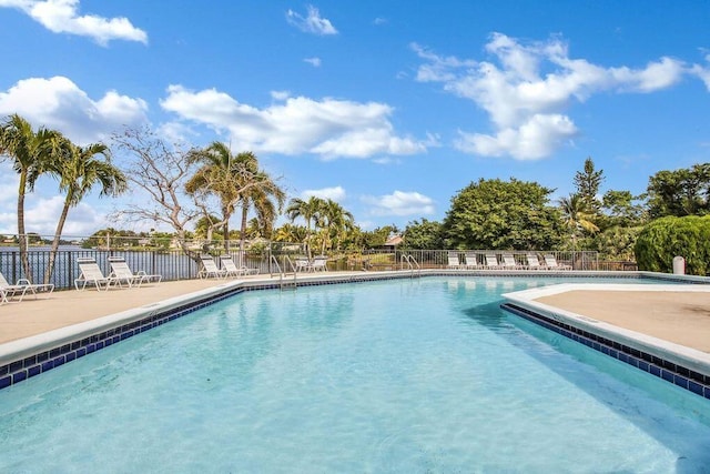 pool with fence and a patio