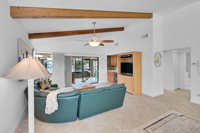 living room with ceiling fan, french doors, light tile patterned floors, and beamed ceiling