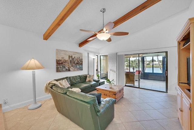 living room with vaulted ceiling with beams, a ceiling fan, a textured ceiling, and light tile patterned flooring