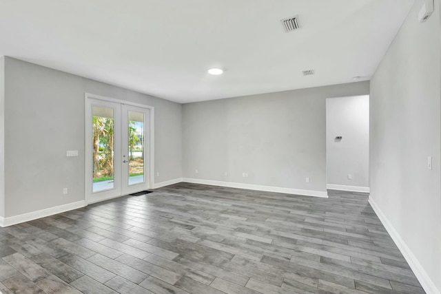 unfurnished room featuring french doors and wood-type flooring