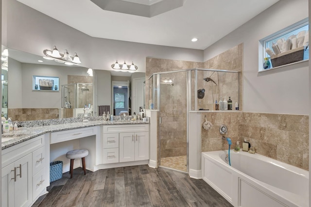 bathroom with vanity, hardwood / wood-style flooring, and independent shower and bath