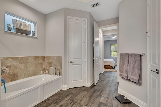 bathroom featuring a tub and hardwood / wood-style flooring