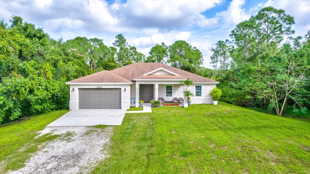 view of front of home with a porch, a front lawn, and a garage