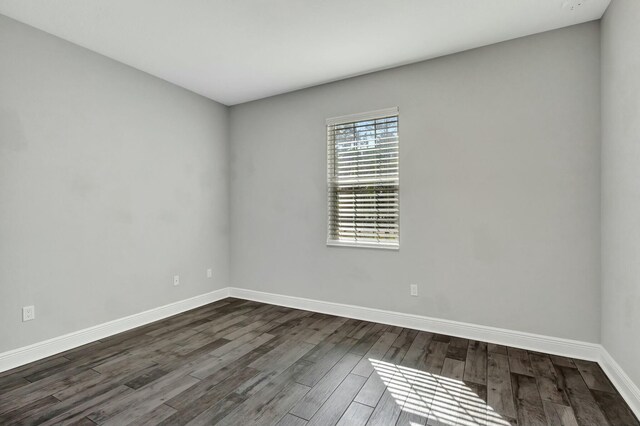 empty room featuring dark wood-type flooring