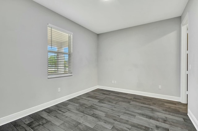 unfurnished room with dark hardwood / wood-style floors