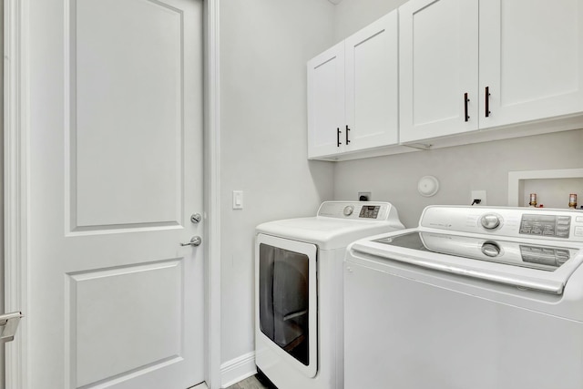 laundry room featuring cabinets and washer and dryer