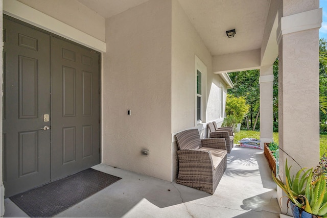 view of exterior entry with covered porch