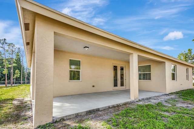 rear view of house with french doors and a patio area