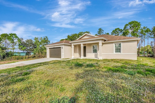 view of front of property with a garage and a front yard