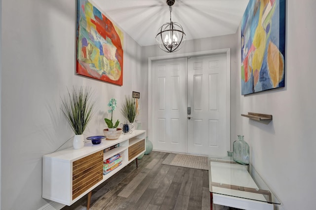 foyer featuring dark wood-type flooring and an inviting chandelier