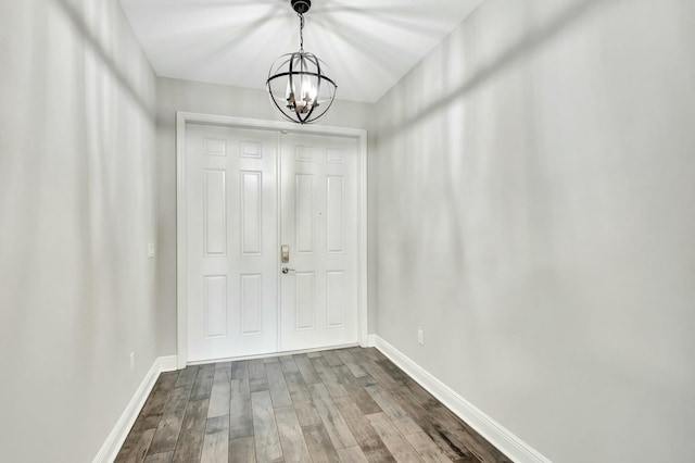 doorway to outside featuring wood-type flooring and a chandelier