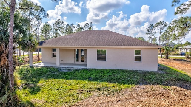 back of property featuring a patio and a lawn