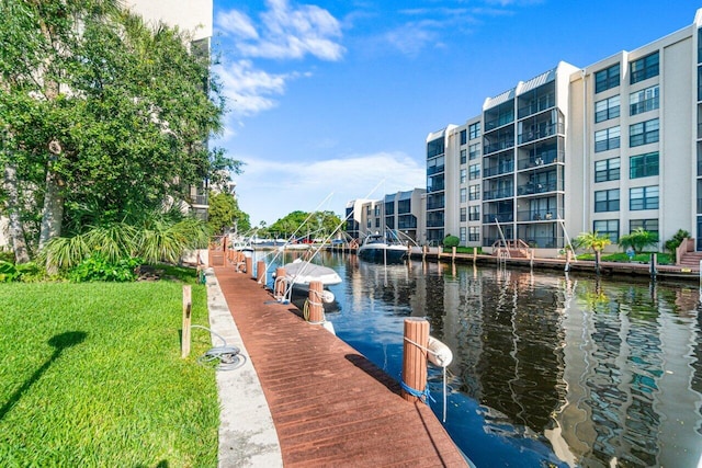 dock area with a yard and a water view