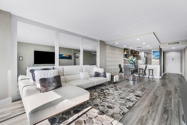 living room with hardwood / wood-style floors and a textured ceiling