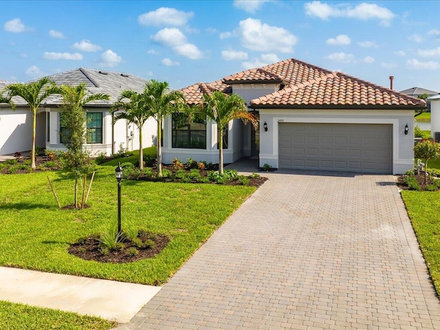 mediterranean / spanish house with a front yard and a garage