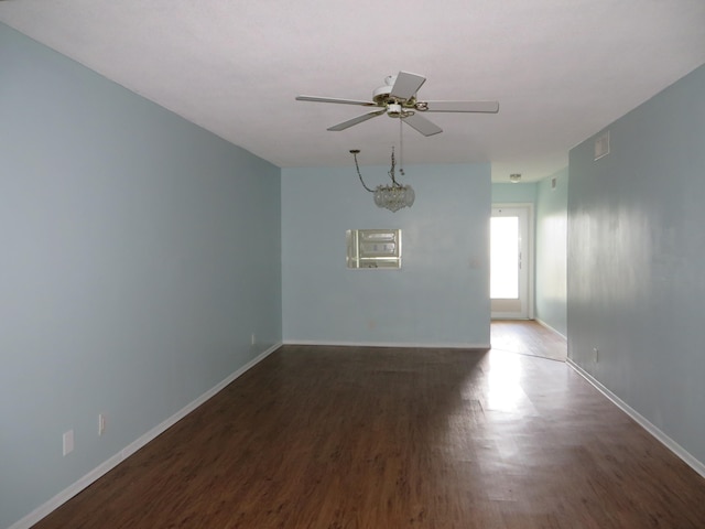 empty room featuring ceiling fan and dark hardwood / wood-style floors