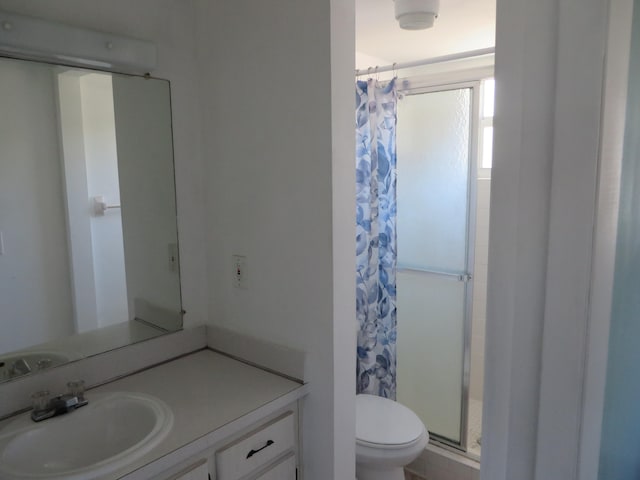 bathroom featuring vanity, toilet, and curtained shower